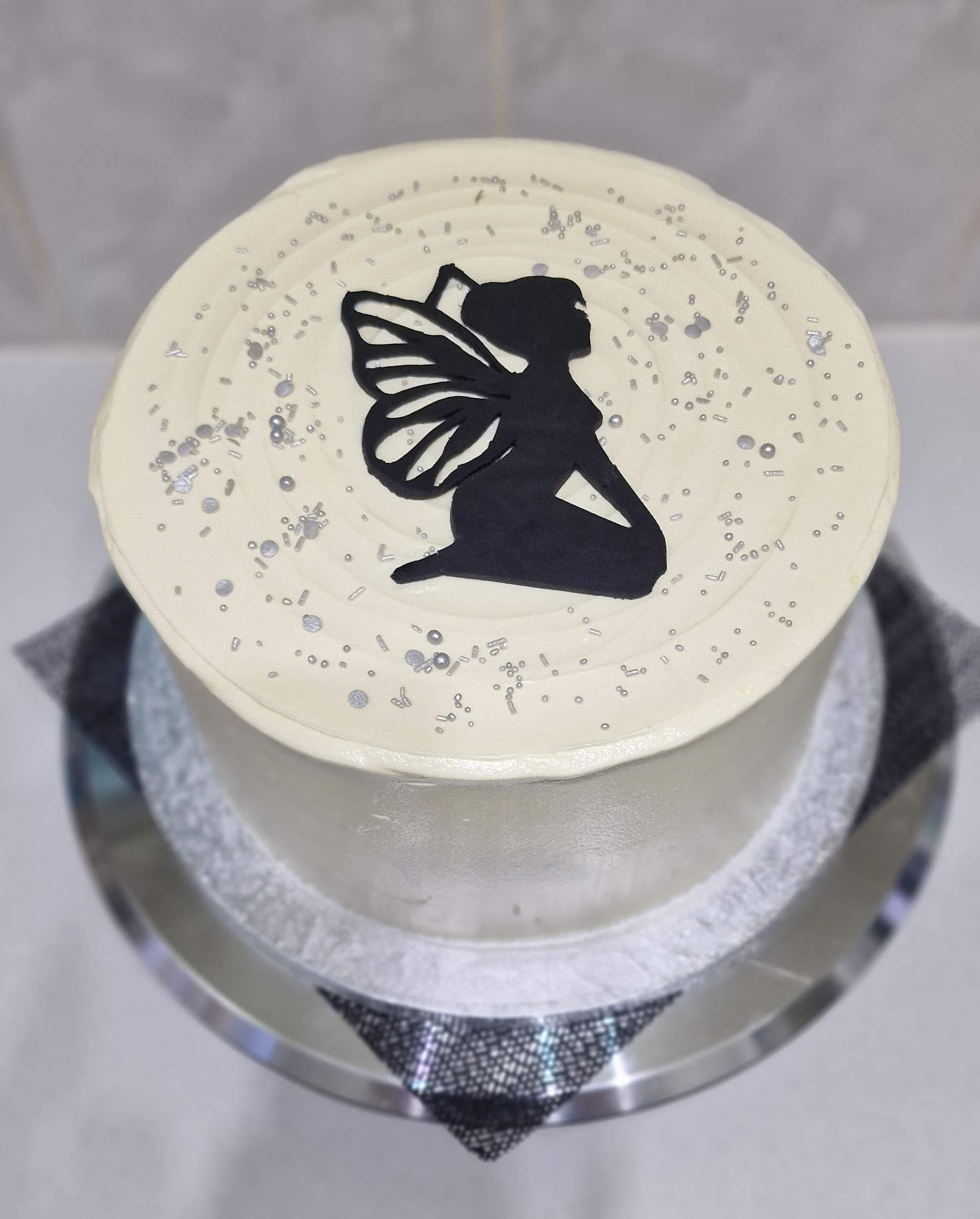 Elegant white frosted custom silhouette fairy birthday cake with silver sprinkles by Fontaines Fancies