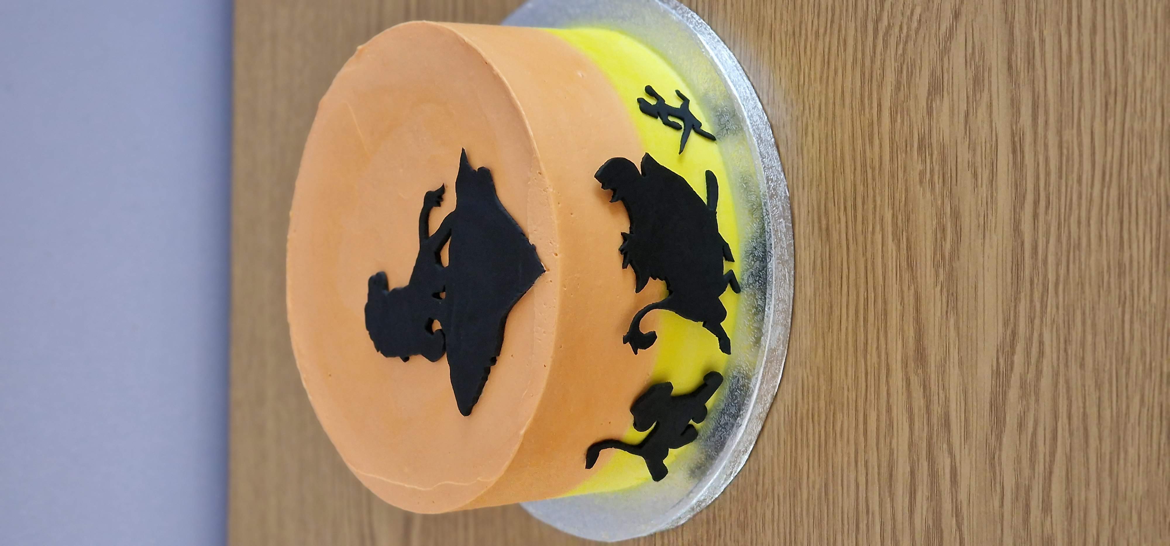 Bespoke Lion King inspired savannah sunset birthday cake featuring clean black fondant silhouette cutouts by Fontaines Fancies