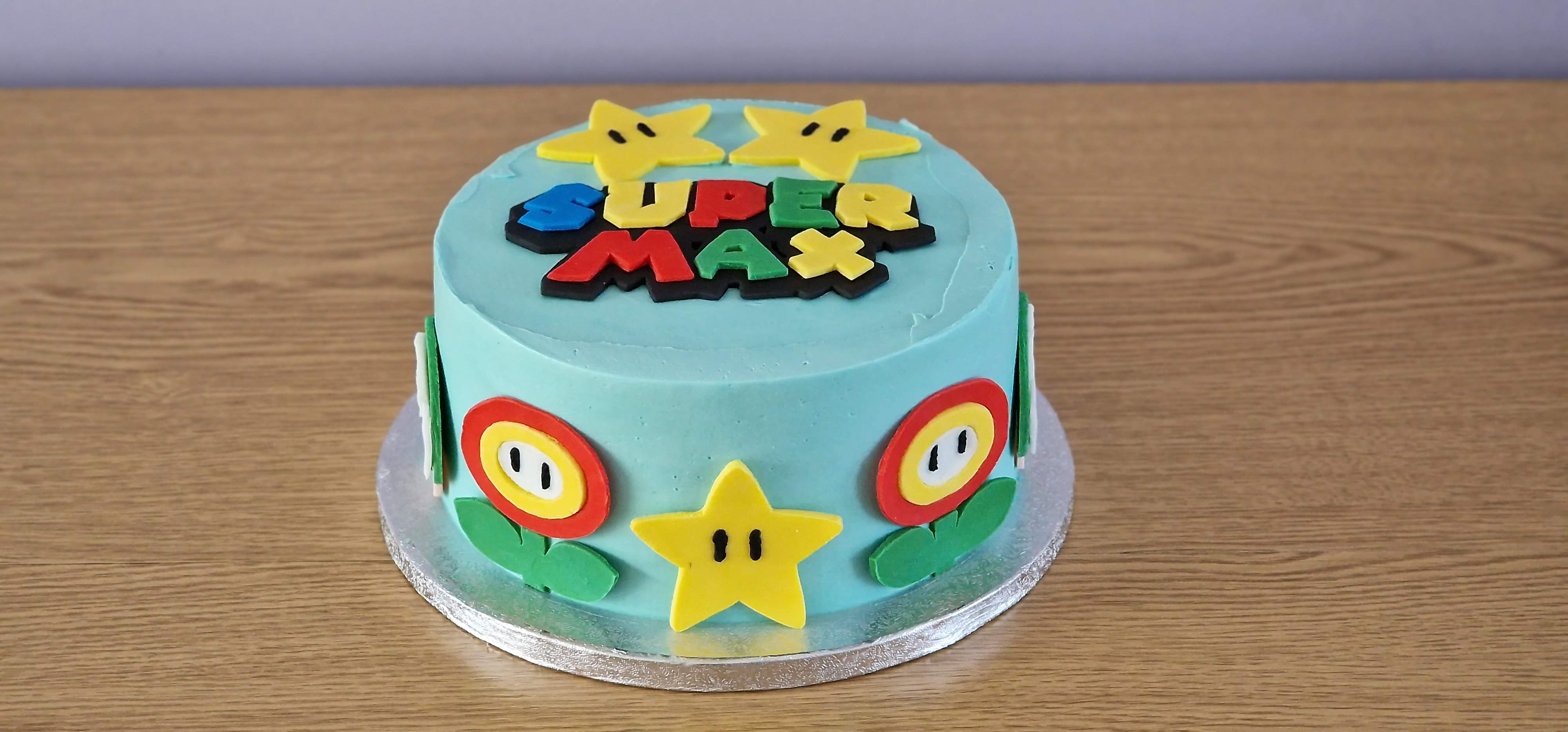 Bespoke light blue iced Oreo cake with custom Super Mario theme decorations for Max by Fontaines Fancies, featuring stars and fire flowers